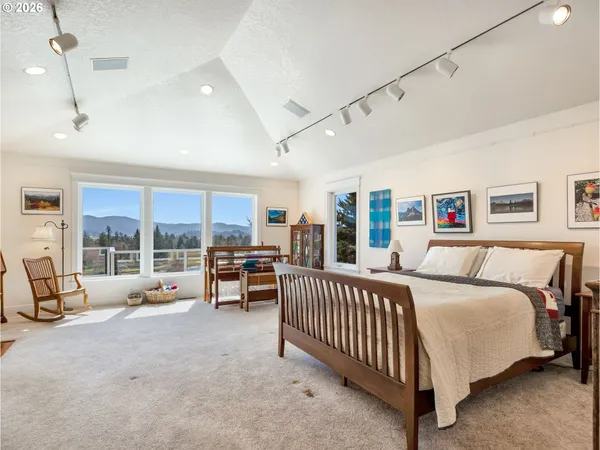 a bedroom with furniture and a large window