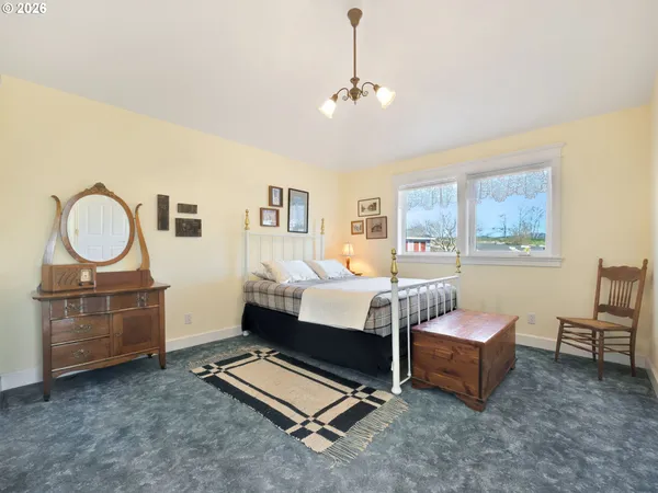 a bedroom with furniture and a window