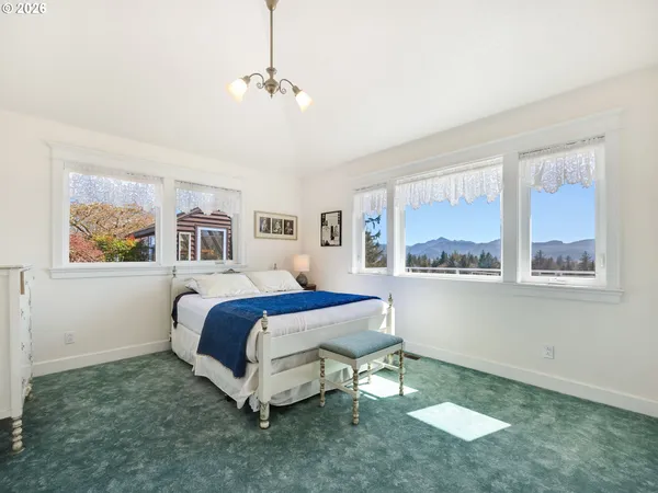 a spacious bedroom with a bed and a window