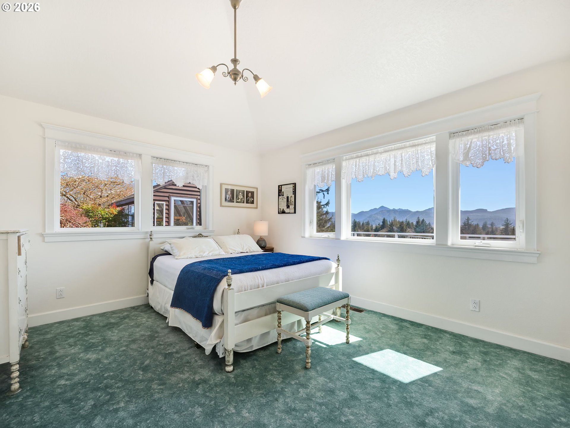14115 Riverview Meadows Lane Nehalem, OR 97131 - Photo 30 of 39 a spacious bedroom with a bed and a window