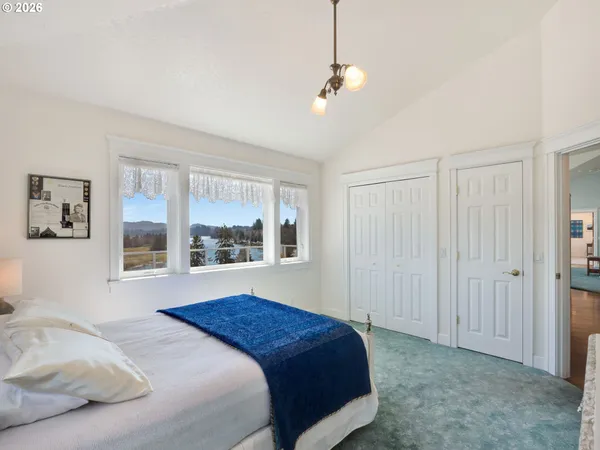 a bedroom with a large bed and a window