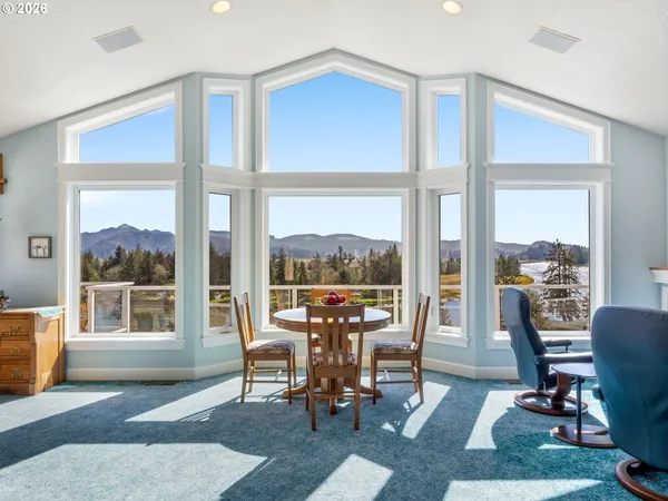a view of a livingroom with furniture and floor to ceiling window