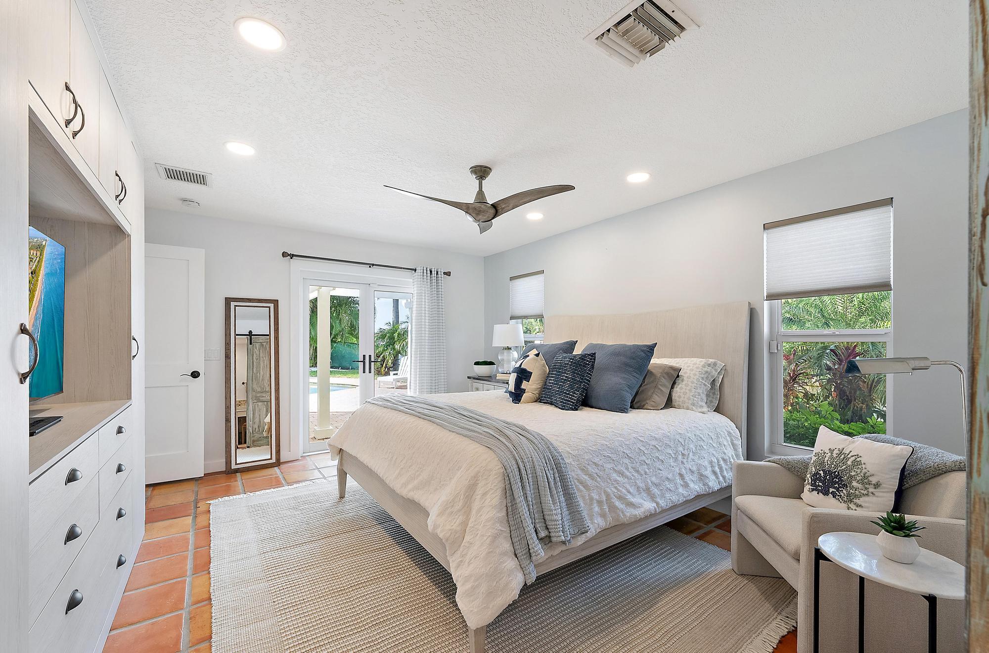 12821 Ellison Wilson Road North Palm Beach, FL 33408 - Photo 17 of 40 a bedroom with a bed and glass door