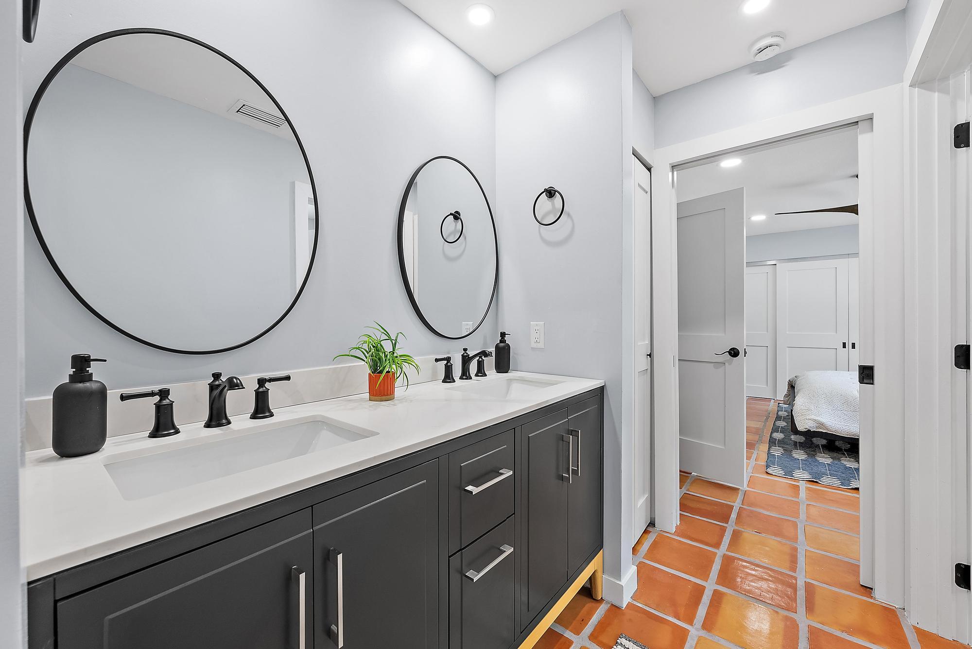 12821 Ellison Wilson Road North Palm Beach, FL 33408 - Photo 20 of 40 a bathroom with a double vanity sink and a mirror
