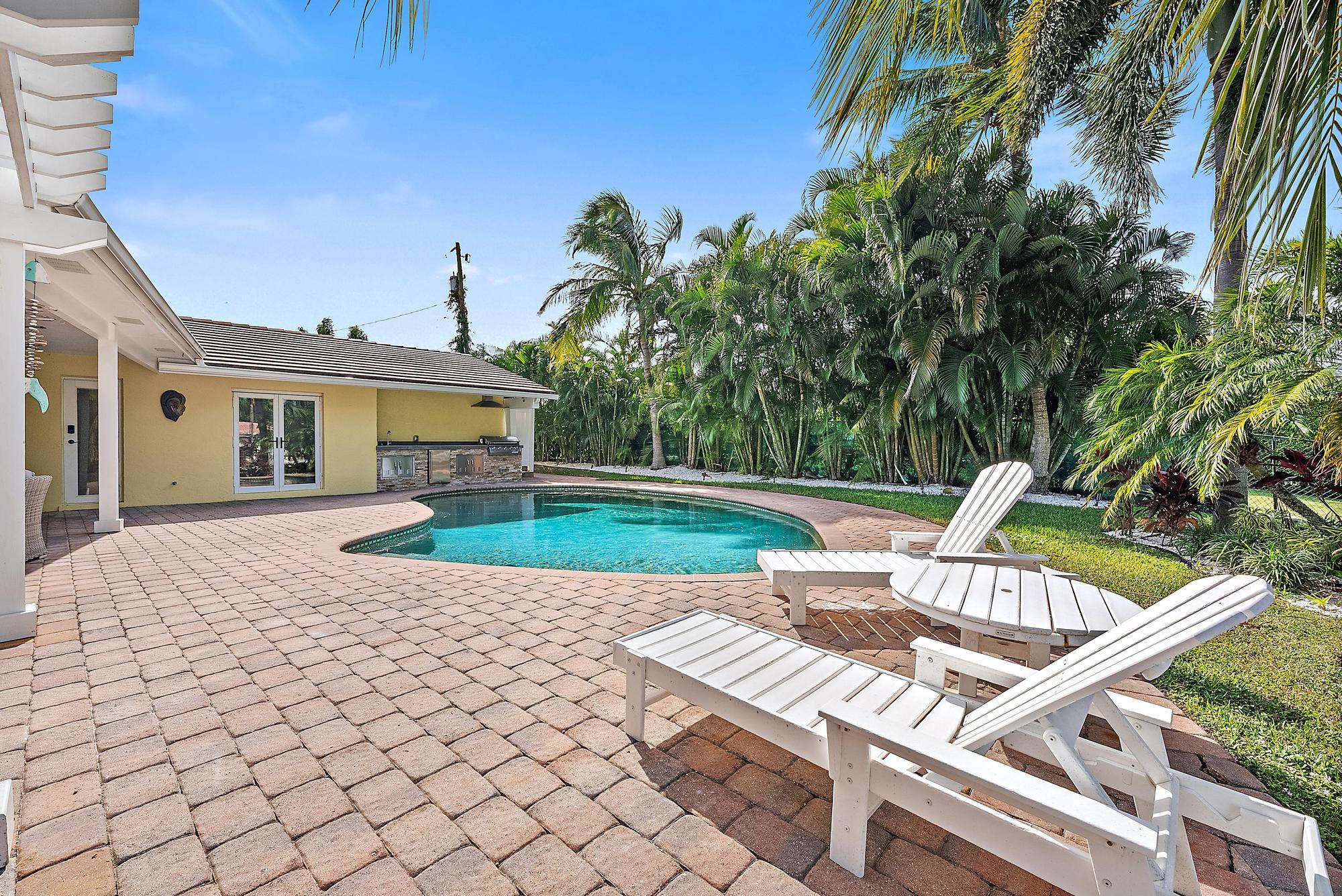 12821 Ellison Wilson Road North Palm Beach, FL 33408 - Photo 28 of 40 a view of a house with backyard porch and sitting area