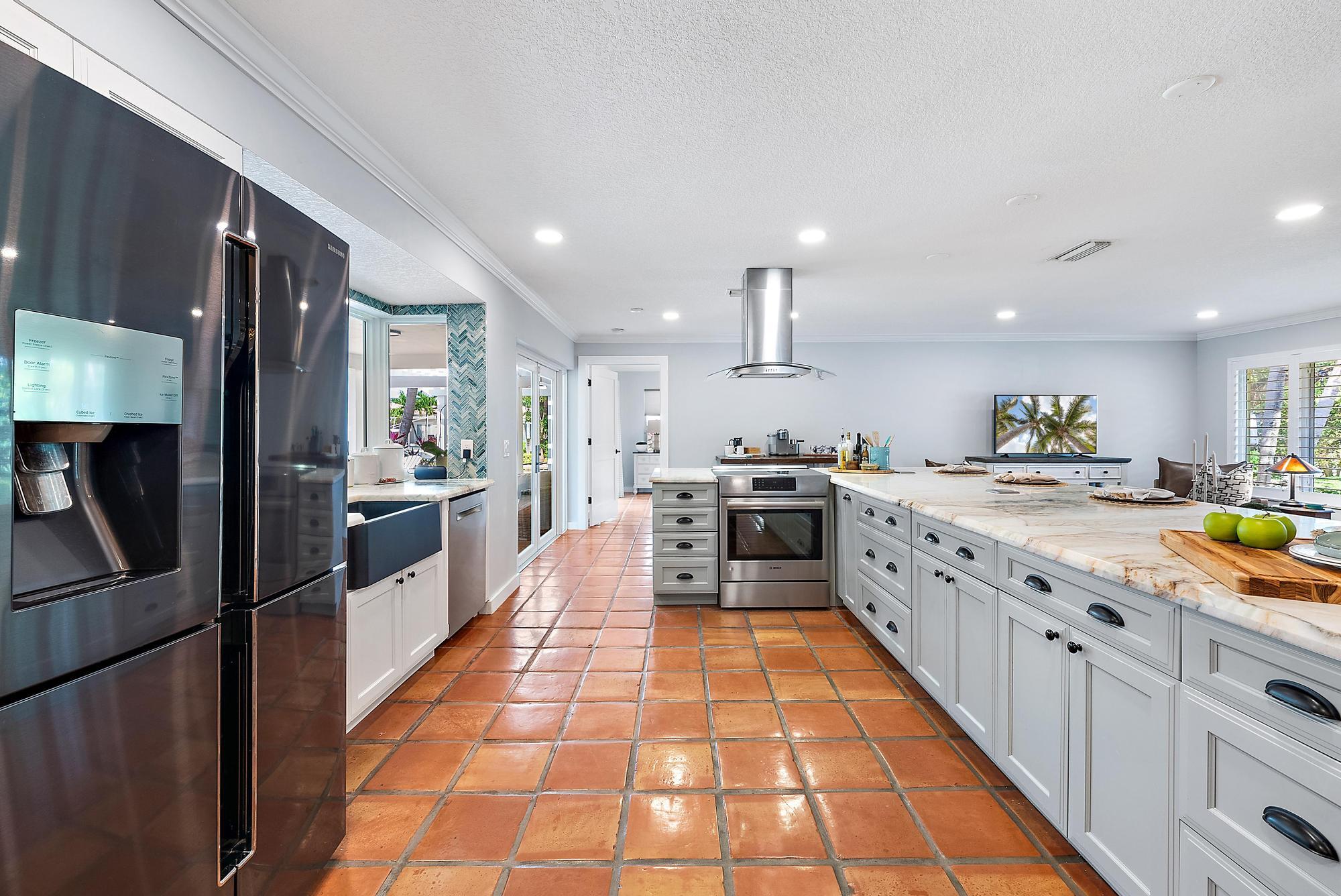 12821 Ellison Wilson Road North Palm Beach, FL 33408 - Photo 9 of 40 a large white kitchen with lots of appliances and cabinets