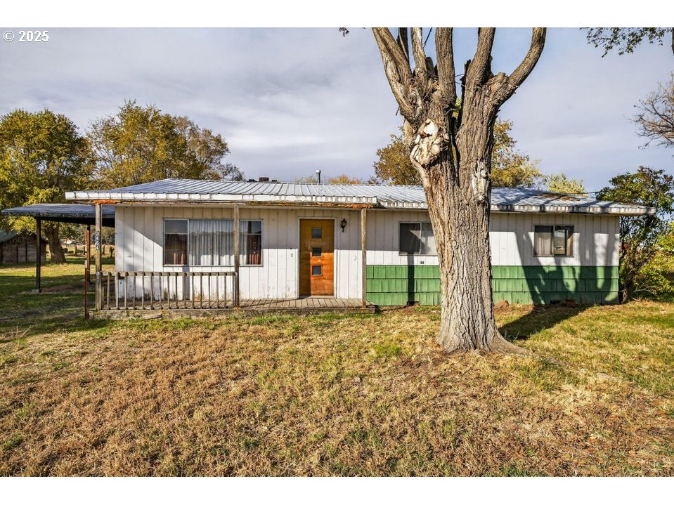 3464 Rimrock Acres Loop Prineville, OR 97754 - Photo 26 of 48 a front view of a house with a garden