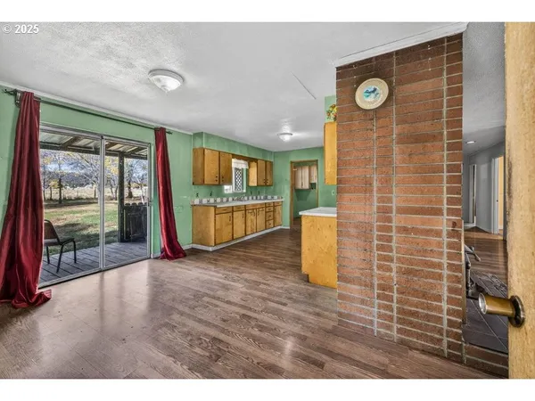 a view of a livingroom with wooden floor and door