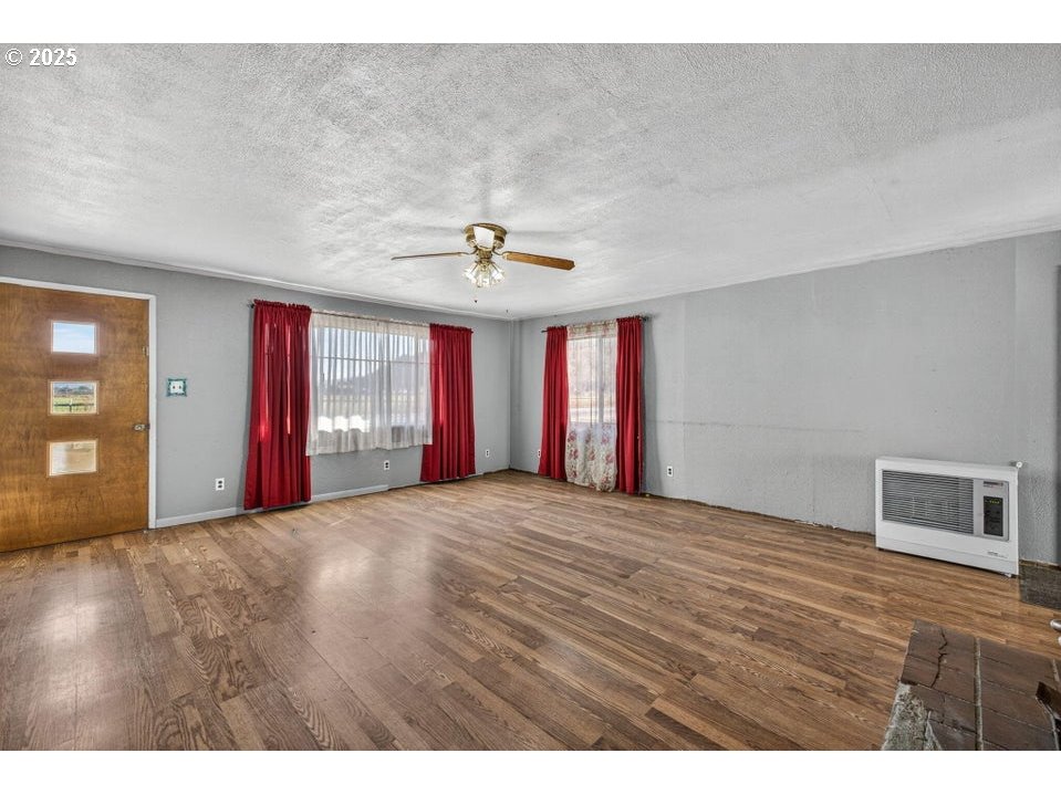 3464 Rimrock Acres Loop Prineville, OR 97754 - Photo 7 of 48 a view of an empty room with window and wooden floor