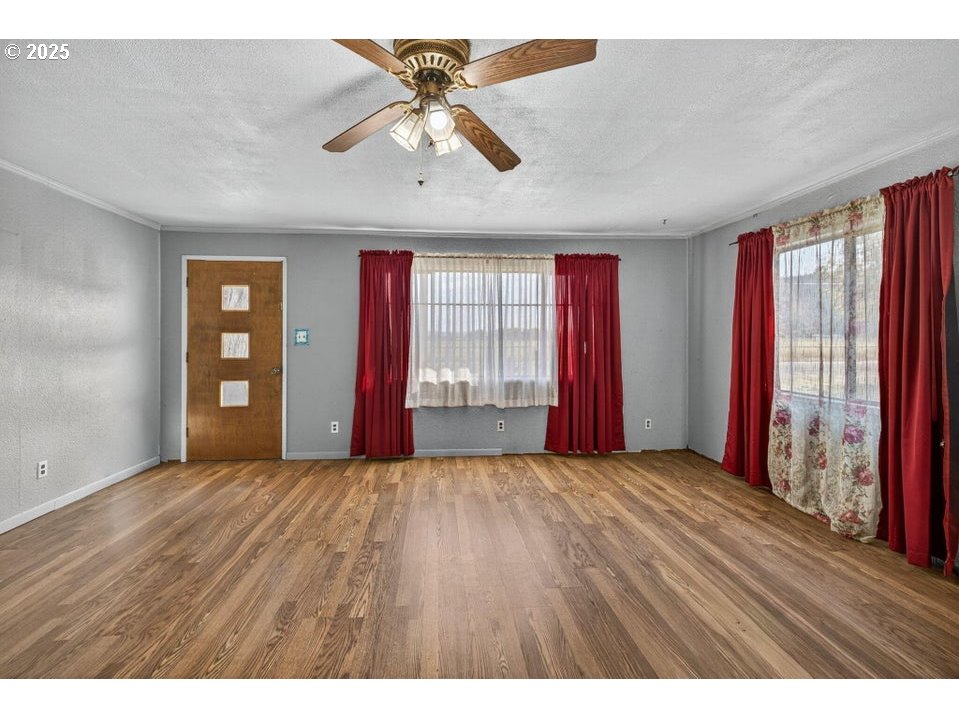 3464 Rimrock Acres Loop Prineville, OR 97754 - Photo 8 of 48 a view of an empty room with window and wooden floor