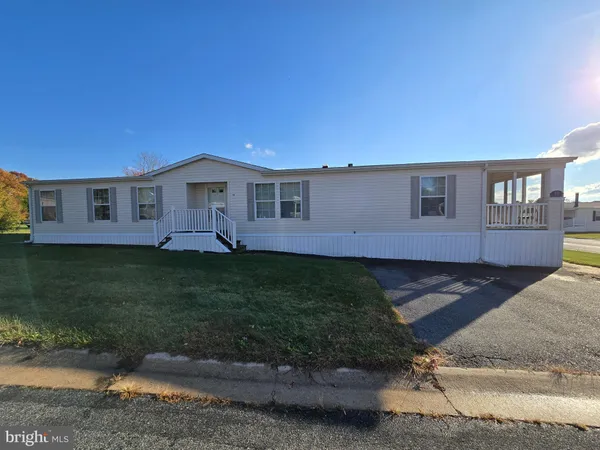 a front view of a house with a garden and yard