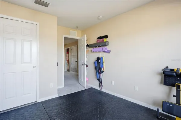 an empty room with wooden floor and closet