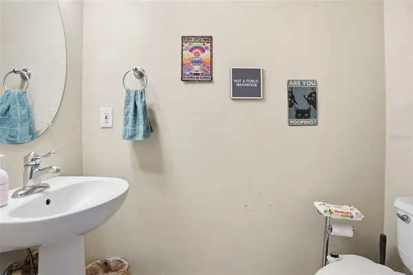 a bathroom with a sink mirror and toilet