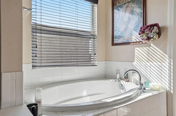 a bathroom with a bathtub and a window
