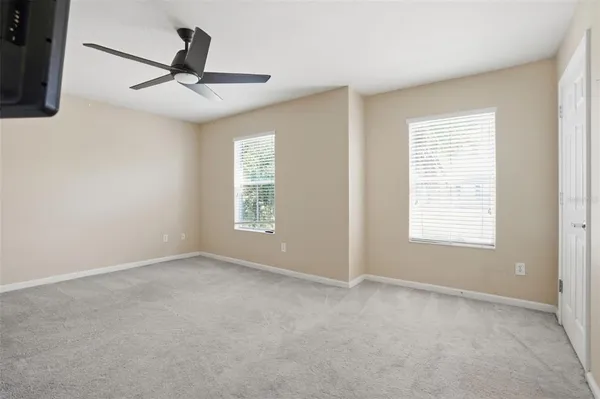a view of a livingroom with a ceiling fan and window