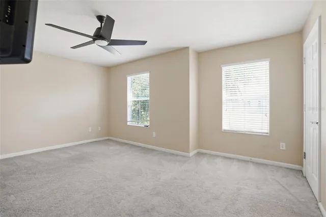 a view of a livingroom with a ceiling fan and window