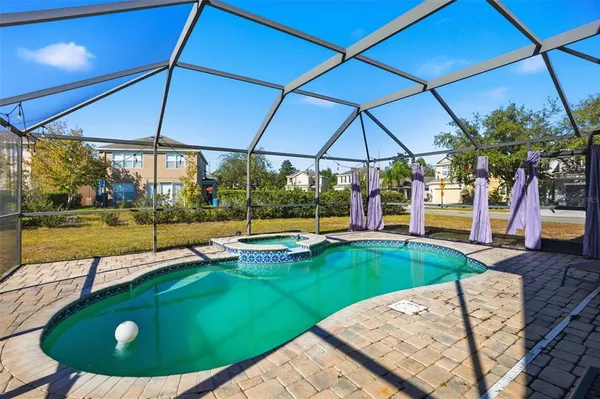 a view of a backyard with swimming pool