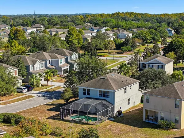 an aerial view of multiple houses with a yard