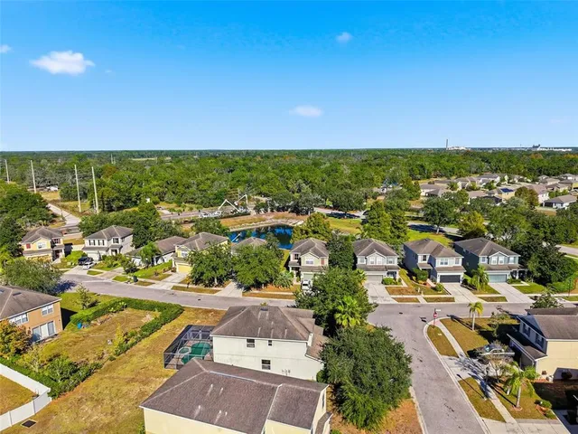an aerial view of residential houses with outdoor space