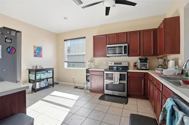 a kitchen with granite countertop a stove sink and cabinets
