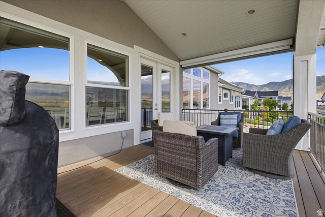 21 Pier Place Tooele, UT 84074 - Photo 82 of 112 Covered outdoor patio featuring composite decking, recessed lighting, and a mountain backdrop