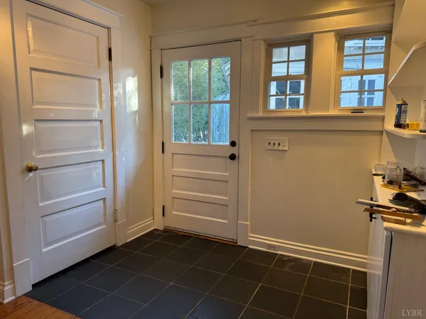 a view of a house with yard and sitting area
