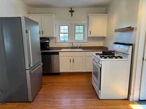 a bathroom with a sink a mirror and a window