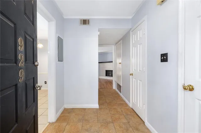 a view of a hallway with wooden floor and cabinet in a room