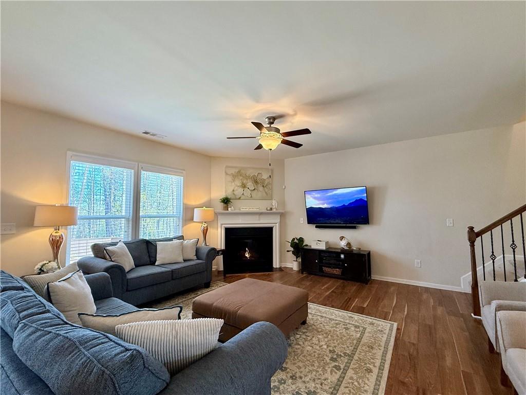 3451 Graham Way Southwest Lilburn, GA 30047 - Photo 18 of 66 a living room with furniture a fireplace and a flat screen tv
