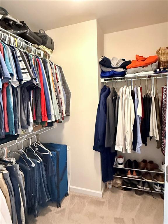 3451 Graham Way Southwest Lilburn, GA 30047 - Photo 22 of 66 a view of walk in closet with clothes and shoes