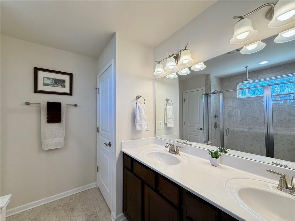 3451 Graham Way Southwest Lilburn, GA 30047 - Photo 25 of 66 a bathroom with a double vanity sink mirror and shower
