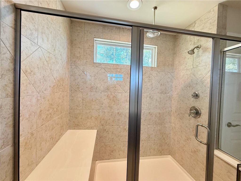 3451 Graham Way Southwest Lilburn, GA 30047 - Photo 26 of 66 a bathroom with a shower and a bathtub