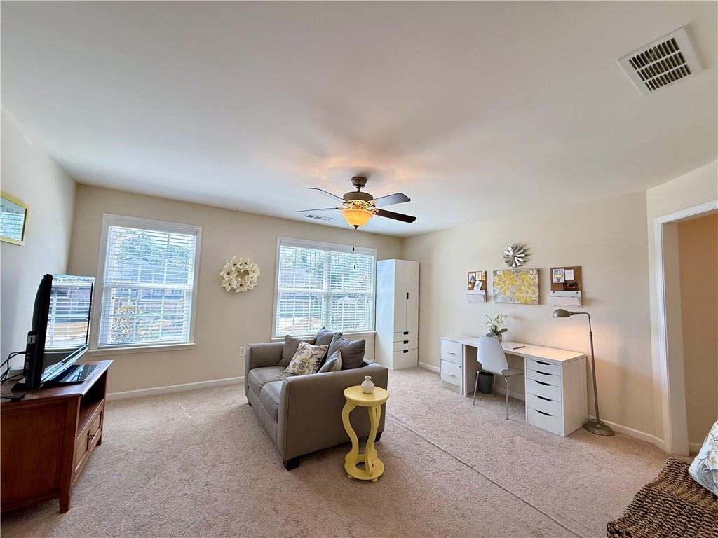3451 Graham Way Southwest Lilburn, GA 30047 - Photo 28 of 66 a living room with furniture a window and a flat screen tv