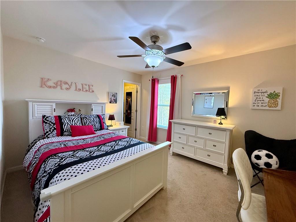 3451 Graham Way Southwest Lilburn, GA 30047 - Photo 32 of 66 a bedroom with a bed and a chandelier