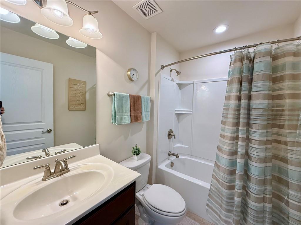 3451 Graham Way Southwest Lilburn, GA 30047 - Photo 33 of 66 a bathroom with a sink a toilet a mirror a bathtub and shower