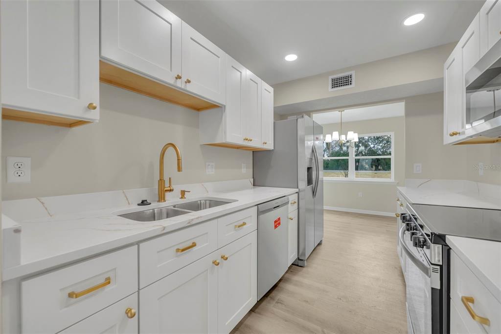 31201 Merry Road Tavares, FL 32778 - Photo 18 of 40 a kitchen with a sink and cabinets