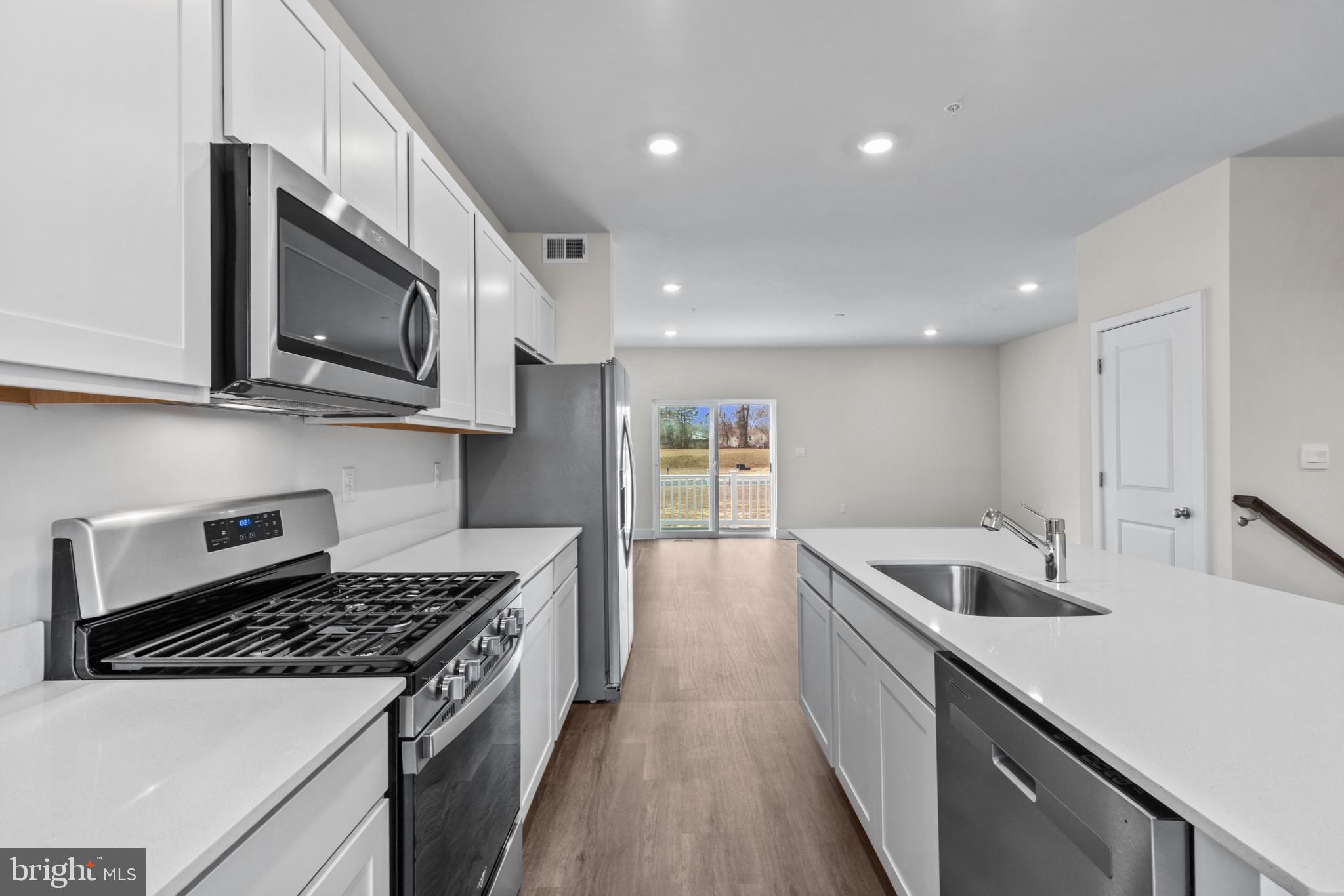 330 Hackley Drive Joppa, MD 21085 - Photo 12 of 32 a kitchen with stainless steel appliances granite countertop a stove and a sink