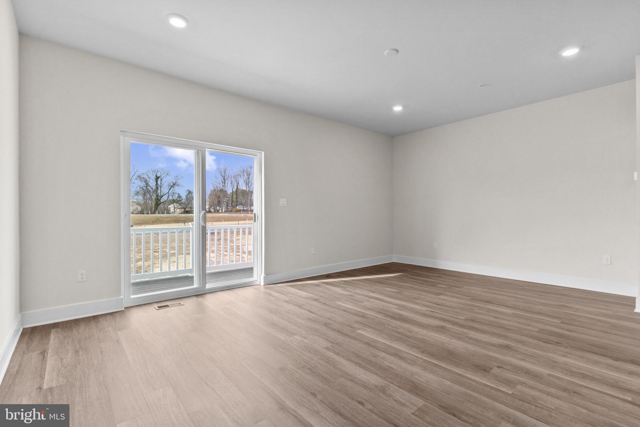 330 Hackley Drive Joppa, MD 21085 - Photo 14 of 32 a view of an empty room with wooden floor and a window