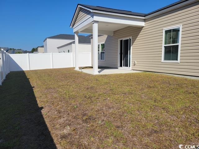 61 S Reindeer Road South Surfside Beach, SC 29575 - Photo 2 of 10 Rear view of property with a patio area and a fenced backyard