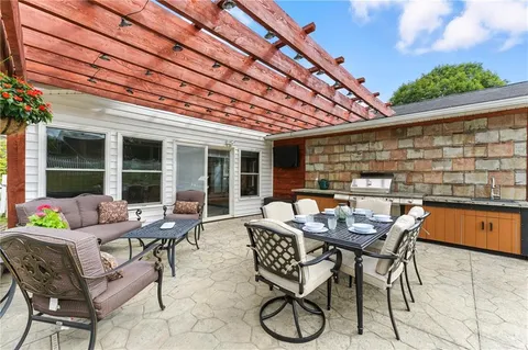 a view of a backyard with plants and a patio