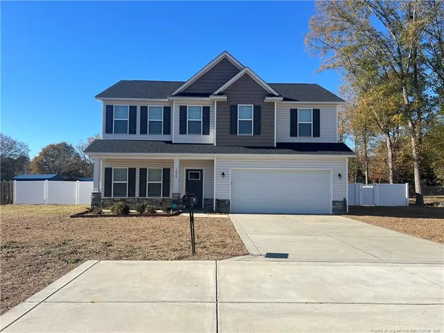 a front view of a house with yard