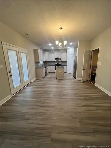 a view of a living room and kitchen with furniture