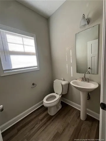 a bathroom with a sink toilet and a mirror