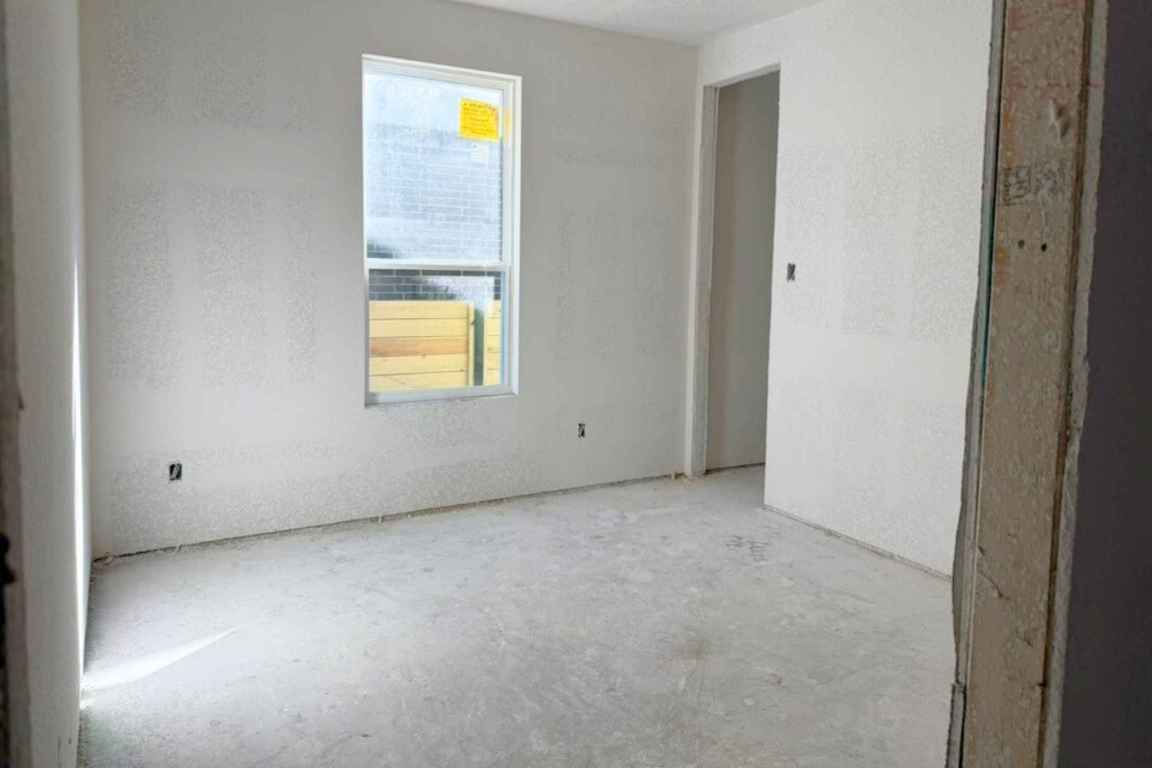 128 Sandrock Trail Georgetown, TX 78633 - Photo 11 of 34 a view of an empty room with a window and kitchen view