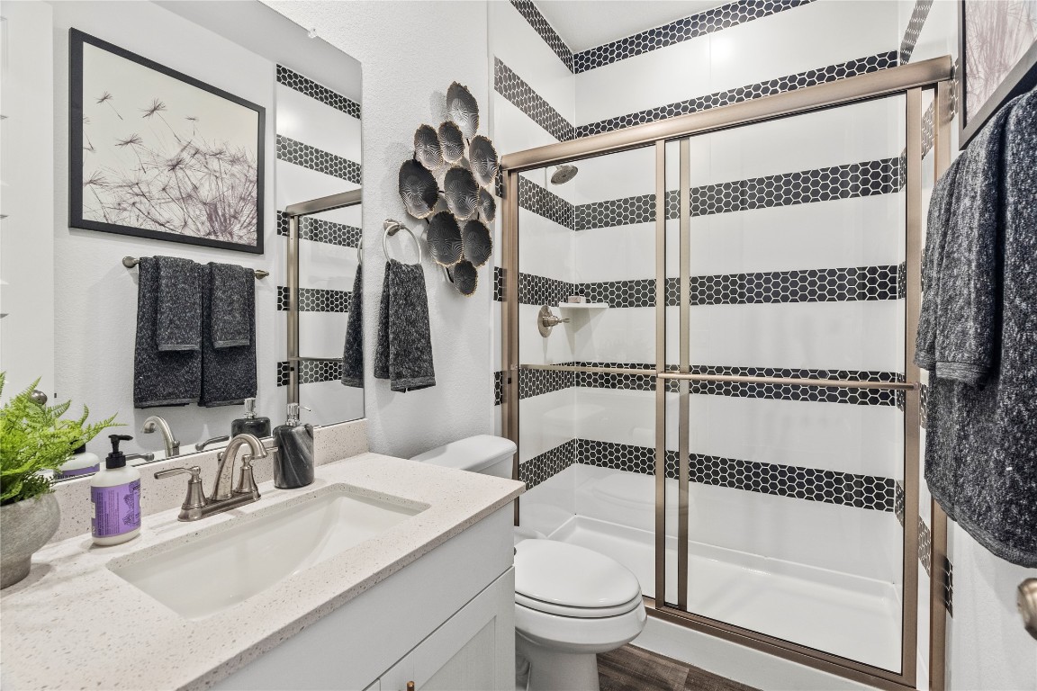 128 Sandrock Trail Georgetown, TX 78633 - Photo 22 of 34 a bathroom with a sink toilet and shower