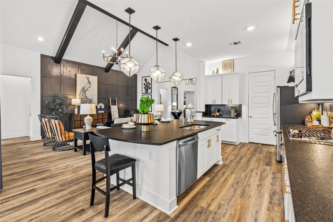128 Sandrock Trail Georgetown, TX 78633 - Photo 24 of 34 a kitchen with stainless steel appliances a table and chairs in it