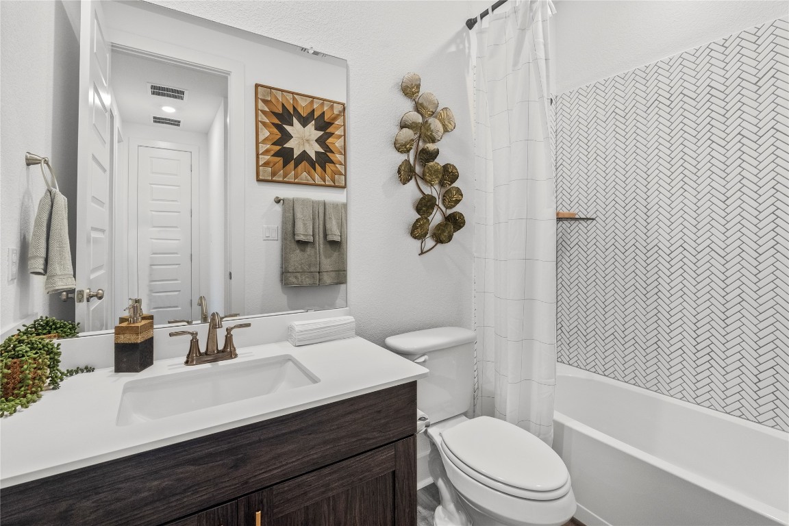 128 Sandrock Trail Georgetown, TX 78633 - Photo 32 of 34 a bathroom with a sink a toilet and shower