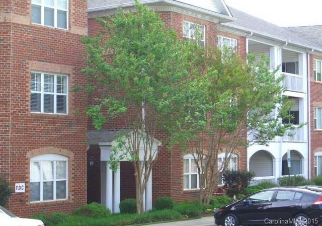 front view of a brick house with a yard