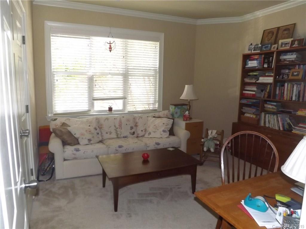 5601 Fairview Road, Unit 9 Charlotte, NC 28209 - Photo 11 of 13 a living room with furniture a bookshelf and a window