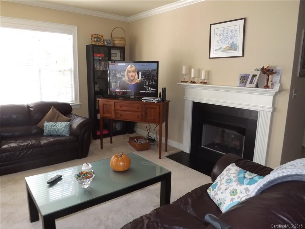 5601 Fairview Road, Unit 9 Charlotte, NC 28209 - Photo 4 of 13 a living room with furniture and a fireplace